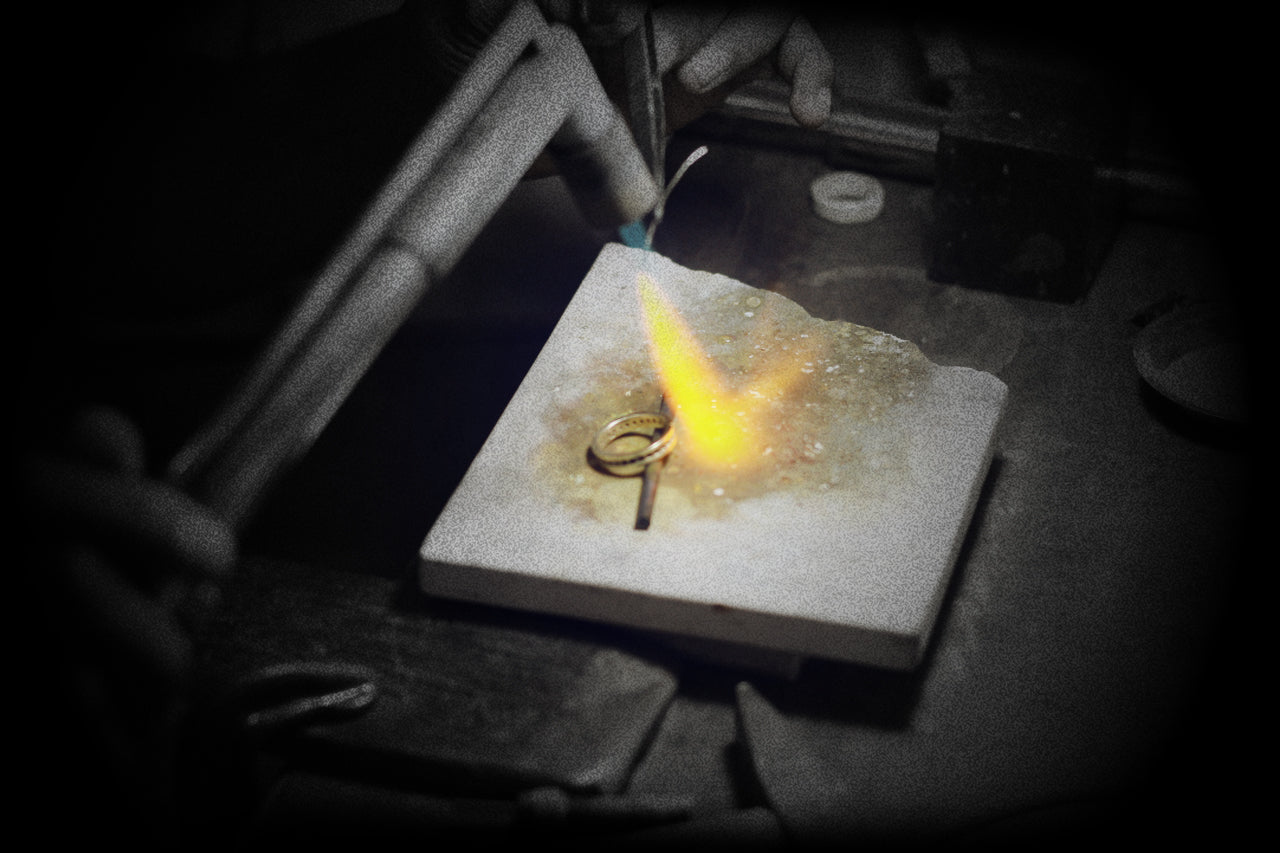Jeweler soldering a silver ring with a precision torch ; การเชื่อมชิ้นงานด้วยเป่าไฟโดยช่าง Madduck Jewels